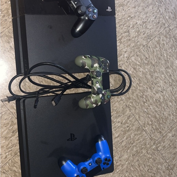 Sony PlayStation Console with Black, Blue, and Camouflage Controllers